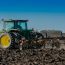 Farm Equipment Finance Companies: A tractor ploughing the field, representing agricultural investment and modern farming